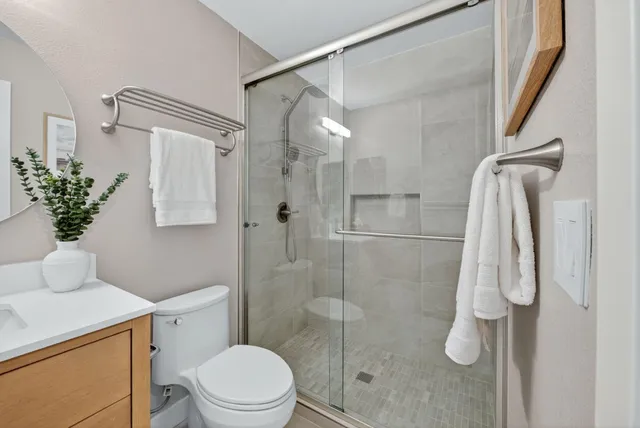 a bathroom with a shower and toilet