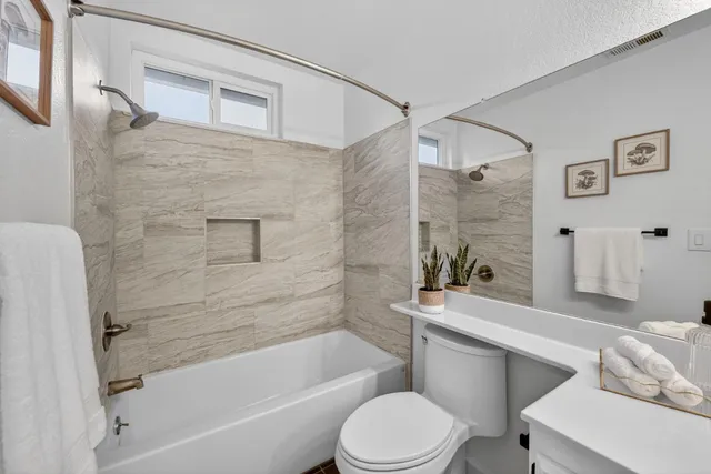 a bathroom with a toilet a sink and bathtub