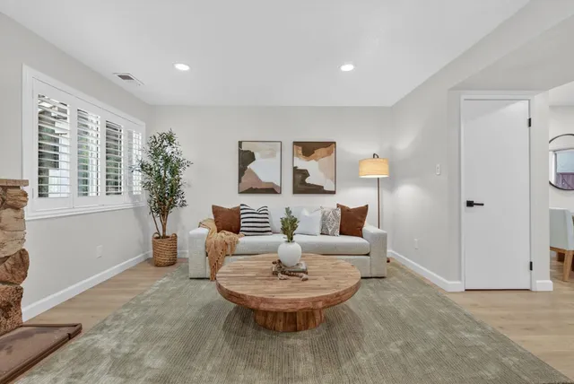 a living room with furniture and a large window