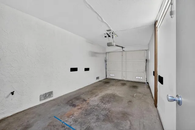 a view of a big room with wooden floor and windows