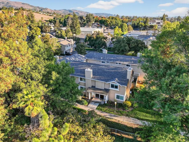 an aerial view of a house with a yard