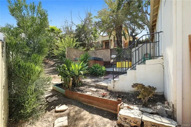 a view of a house with yard and sitting area