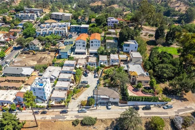 an aerial view of residential houses with outdoor space