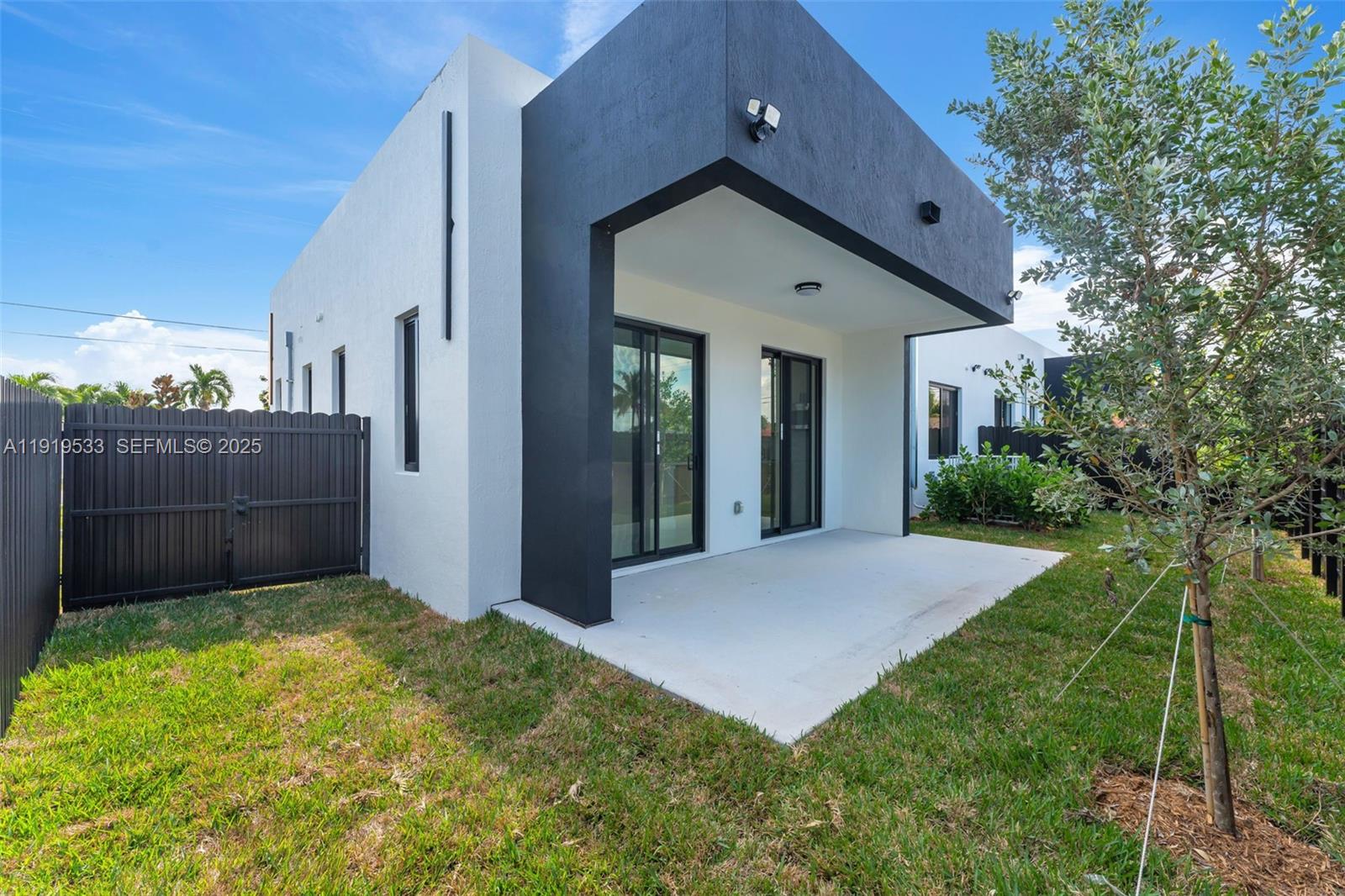 21911 Southwest 124th Avenue Miami, FL 33183 - Photo 21 of 24 a view of a house with brick walls and a yard with plants