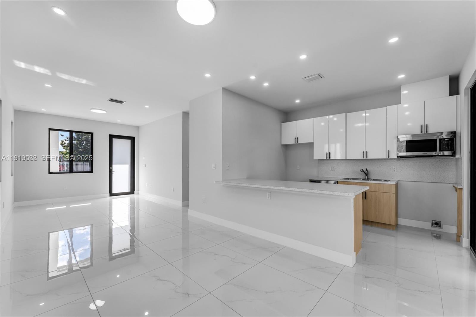 21911 Southwest 124th Avenue Miami, FL 33183 - Photo 6 of 24 a large kitchen with stainless steel appliances kitchen island granite countertop a sink and cabinets