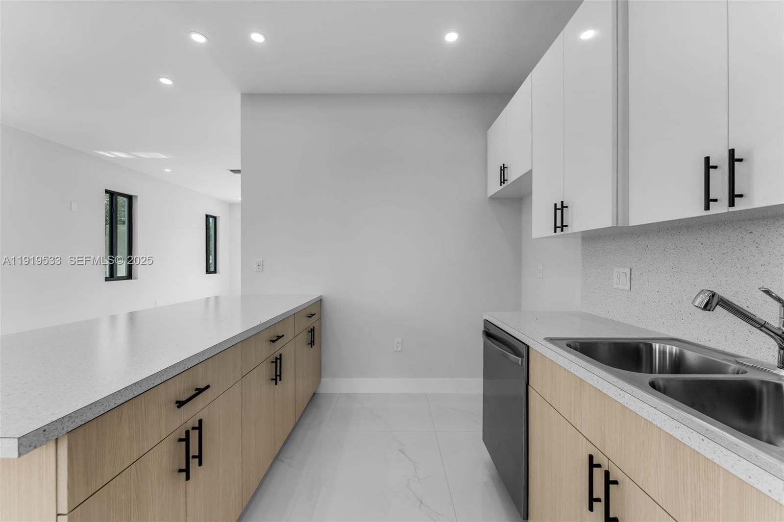 21911 Southwest 124th Avenue Miami, FL 33183 - Photo 9 of 24 a kitchen with granite countertop white cabinets and white appliances