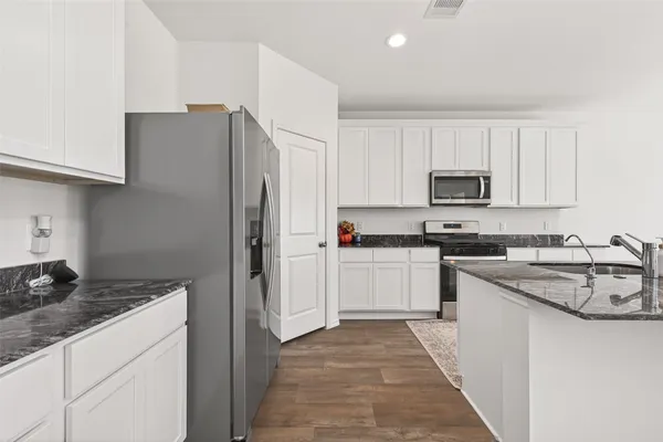a kitchen with a refrigerator stove and sink