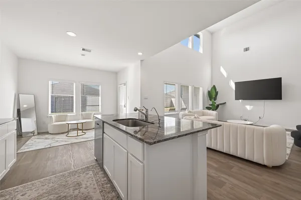 a living room with furniture and a flat screen tv