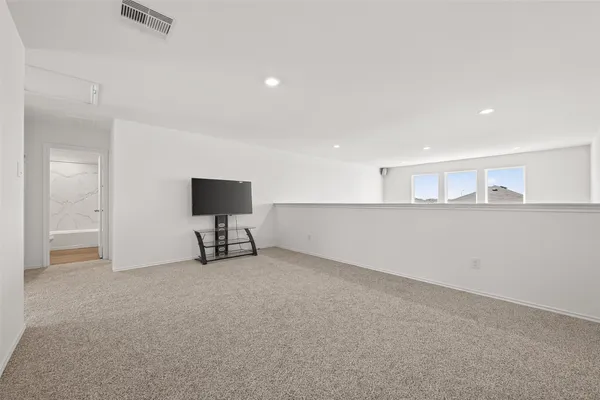 a view of an empty room with kitchen