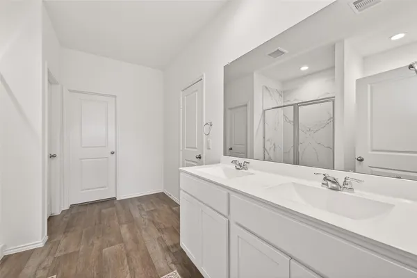 a bathroom with a sink double vanity and a mirror