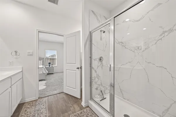 a bathroom with a shower and a sink