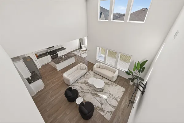 a living room with furniture and a floor to ceiling window