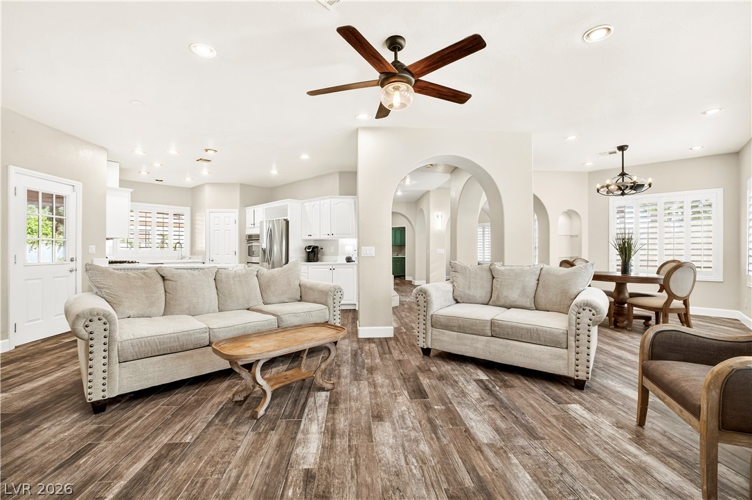 1135 Calico Ridge Drive Henderson, NV 89011 - Photo 16 of 86 An airy living area flows into a bright kitchen and dining space, perfect for gathering.