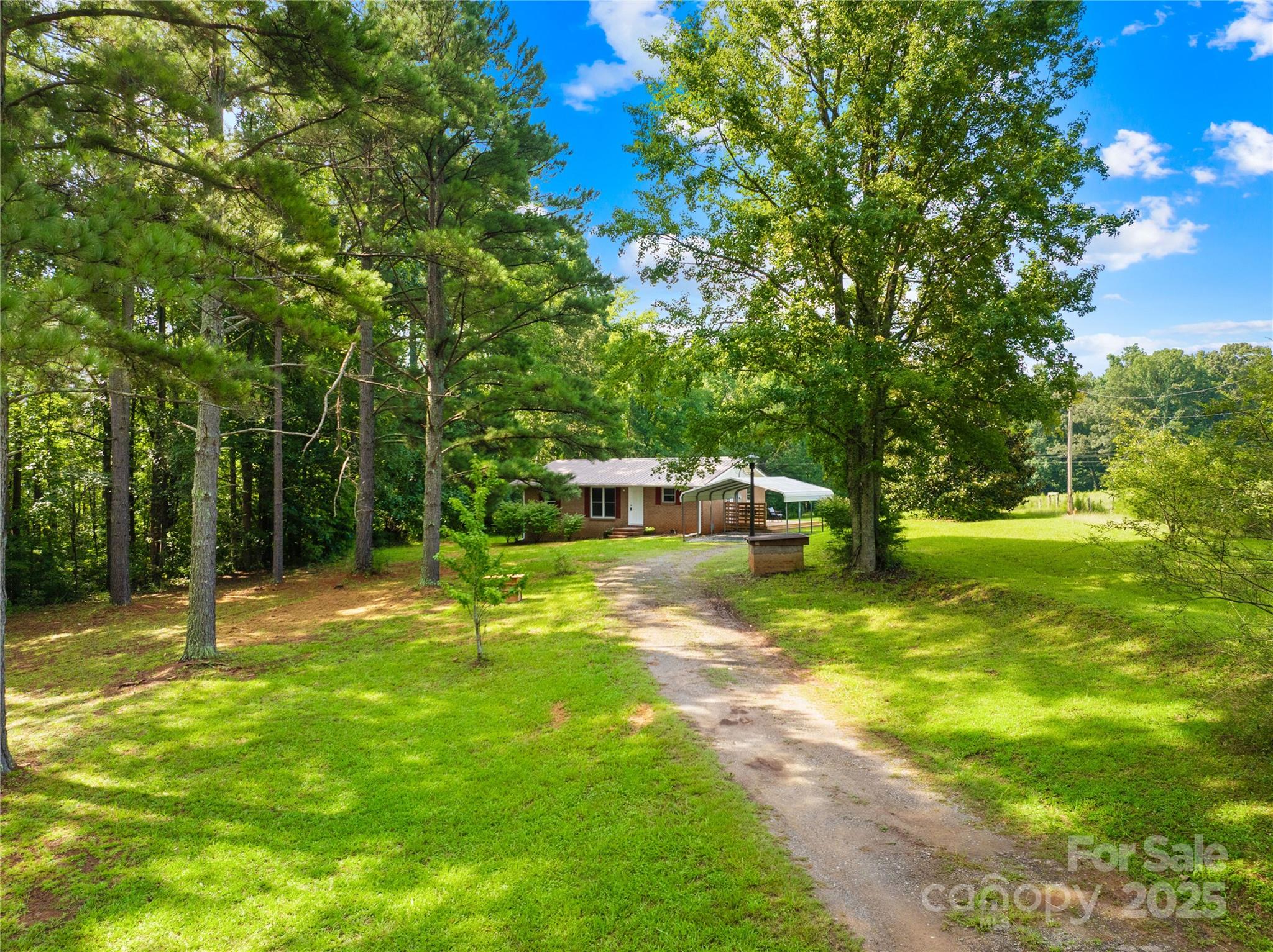 2333 Howells Ferry Road Hickory Grove, SC 29717 - Photo 1 of 30 a swimming pool with lots of tress in front of it