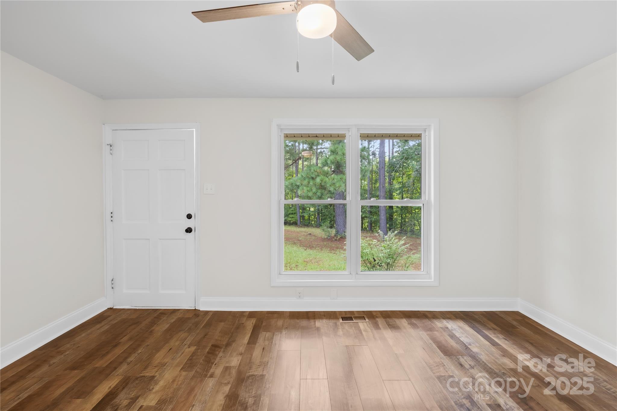 2333 Howells Ferry Road Hickory Grove, SC 29717 - Photo 16 of 30 an empty room with wooden floor and windows