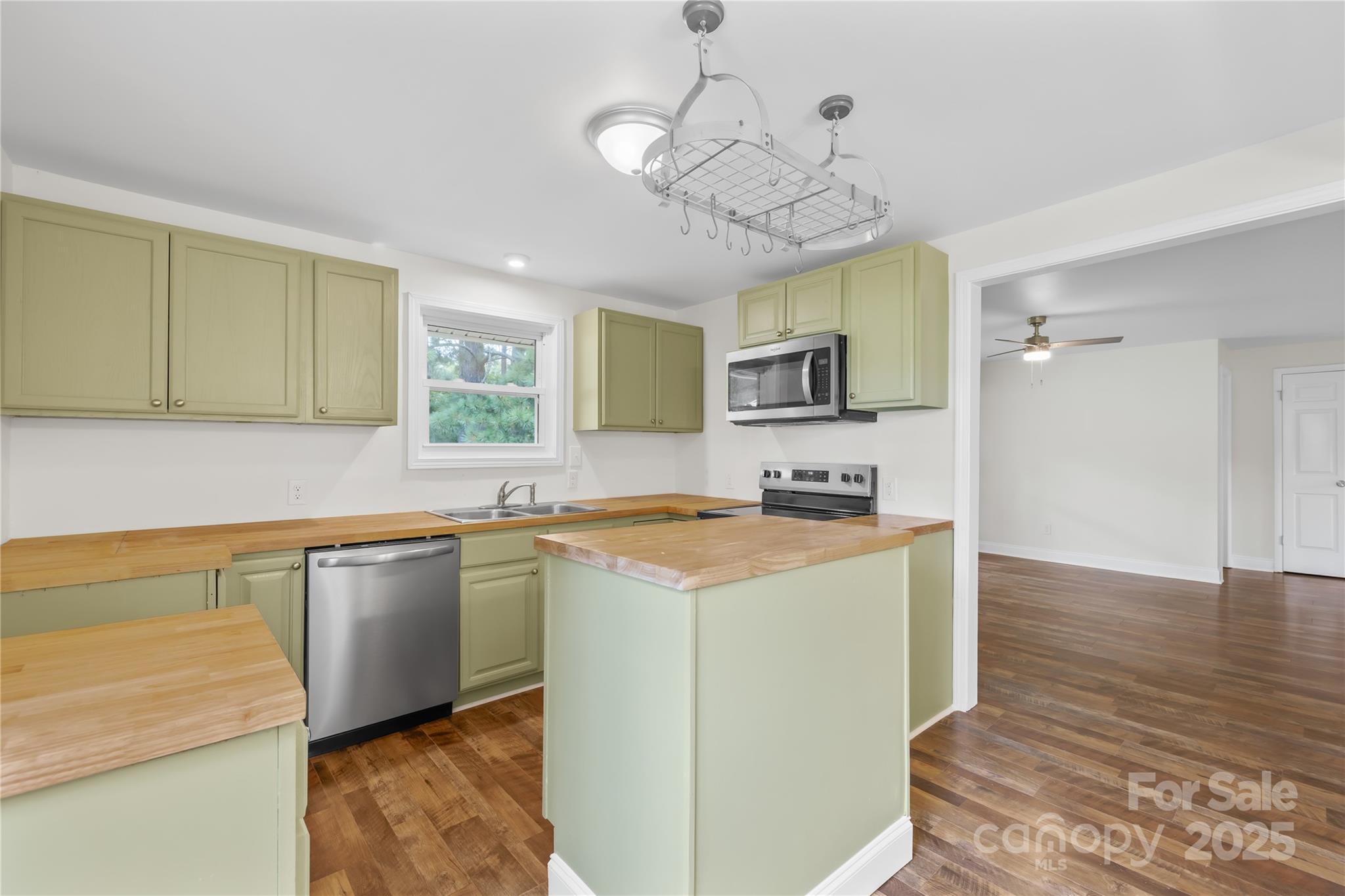 2333 Howells Ferry Road Hickory Grove, SC 29717 - Photo 21 of 30 a kitchen with stainless steel appliances granite countertop a sink a stove and a wooden floors