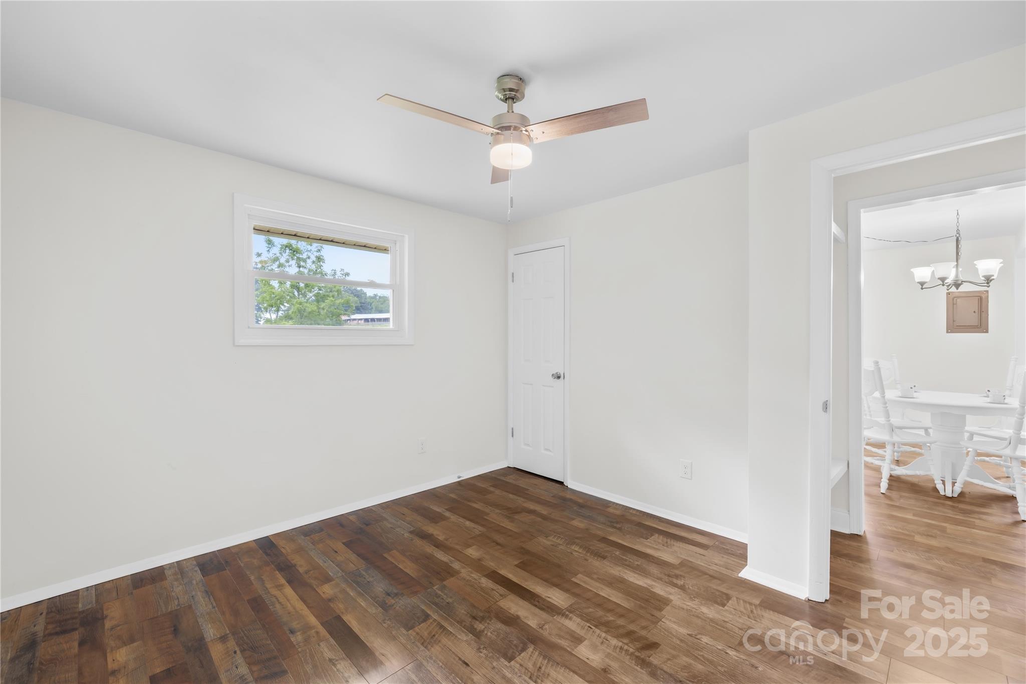 2333 Howells Ferry Road Hickory Grove, SC 29717 - Photo 27 of 30 a view of empty room with wooden floor and ceiling fan