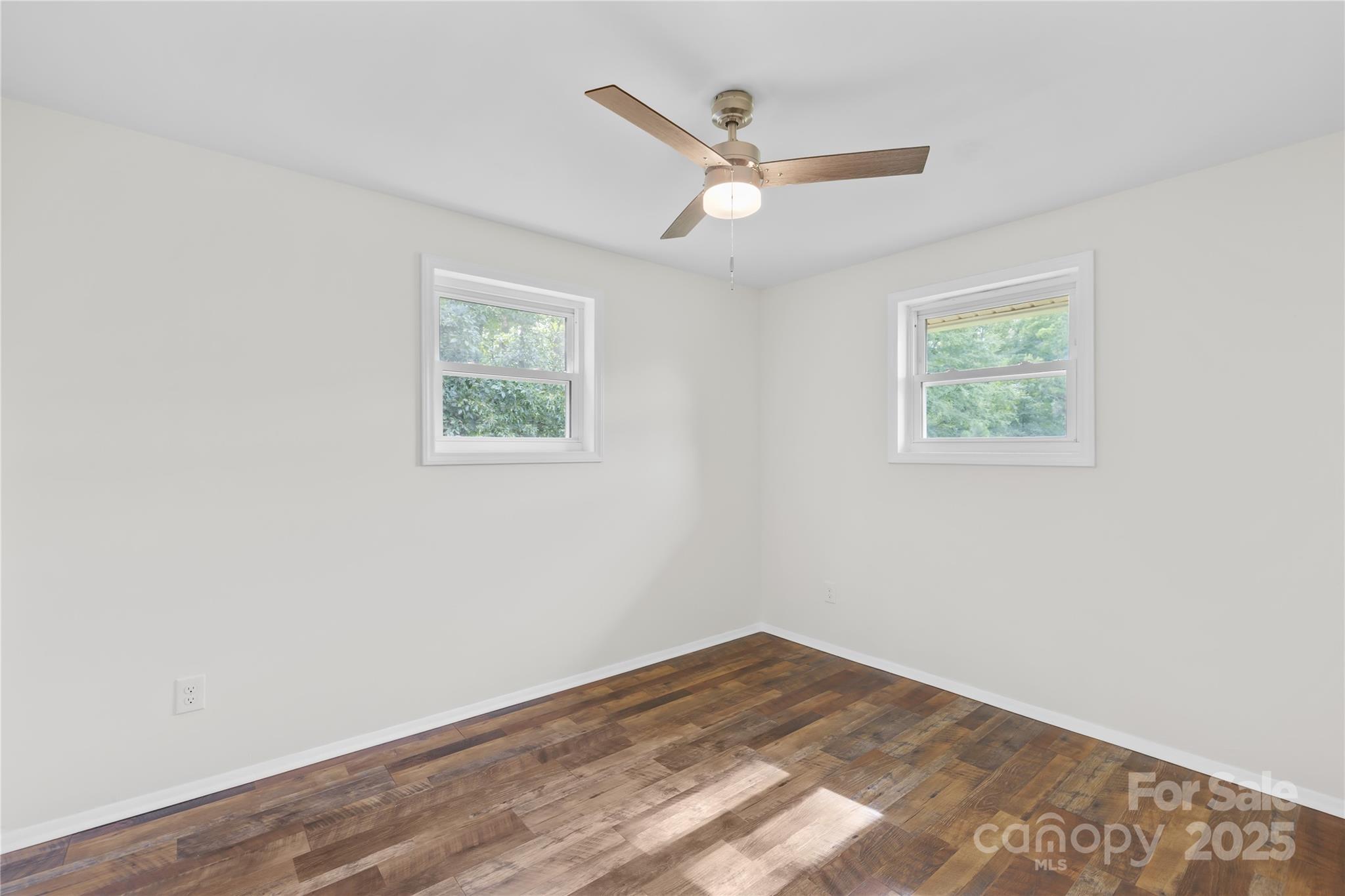 2333 Howells Ferry Road Hickory Grove, SC 29717 - Photo 29 of 30 an empty room with wooden floor ceiling fan and window