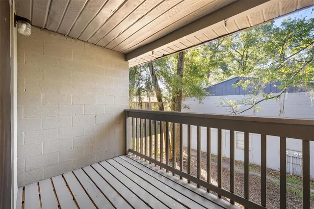 a view of a porch with wooden floor and outdoor space