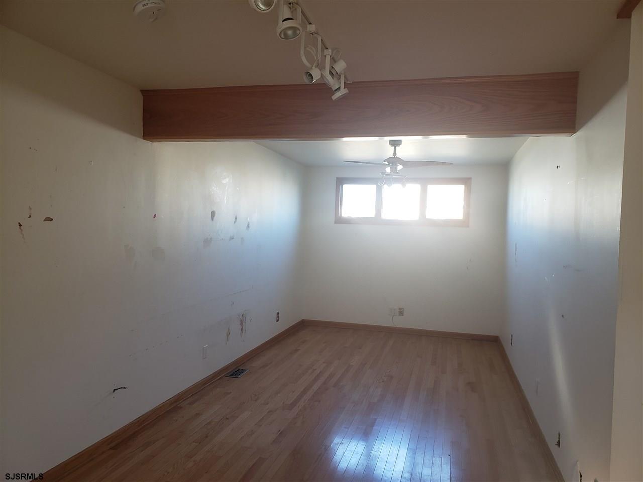 16 Vardon Road Brigantine, NJ 08203 - Photo 11 of 20 an empty room with wooden floor and windows