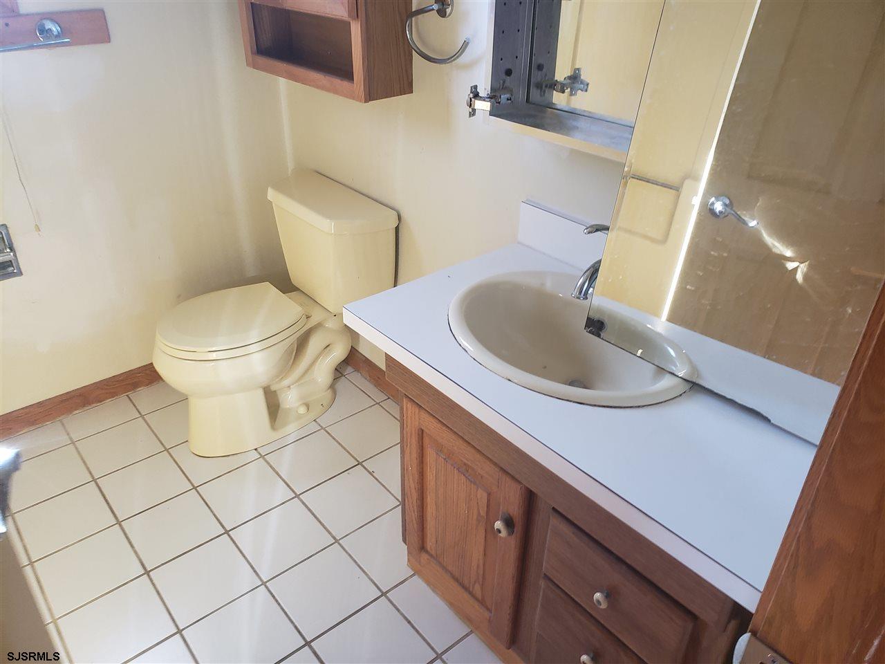16 Vardon Road Brigantine, NJ 08203 - Photo 17 of 20 a bathroom with a sink a toilet and mirror
