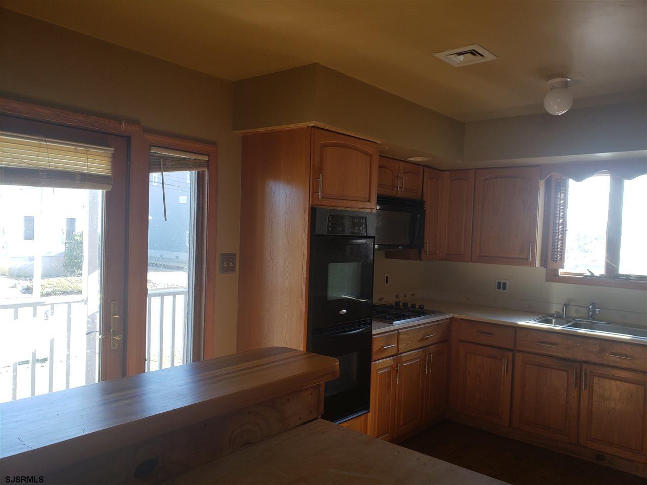 16 Vardon Road Brigantine, NJ 08203 - Photo 8 of 20 a kitchen with a refrigerator and a sink