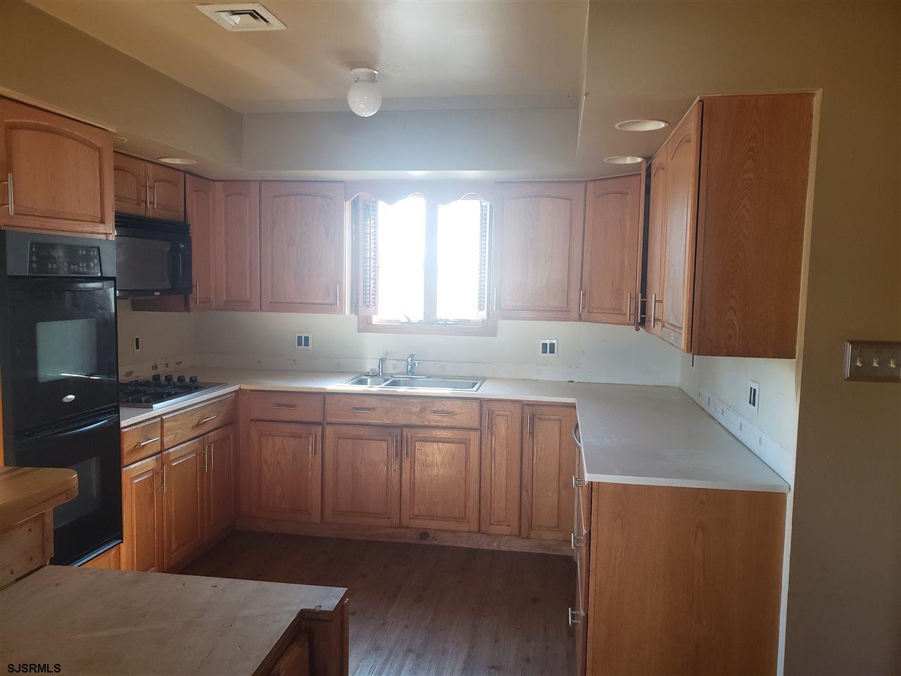 16 Vardon Road Brigantine, NJ 08203 - Photo 9 of 20 a kitchen with granite countertop a sink stove and cabinets