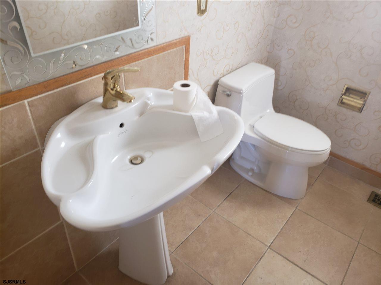 16 Vardon Road Brigantine, NJ 08203 - Photo 10 of 20 a bathroom with a toilet sink and mirror