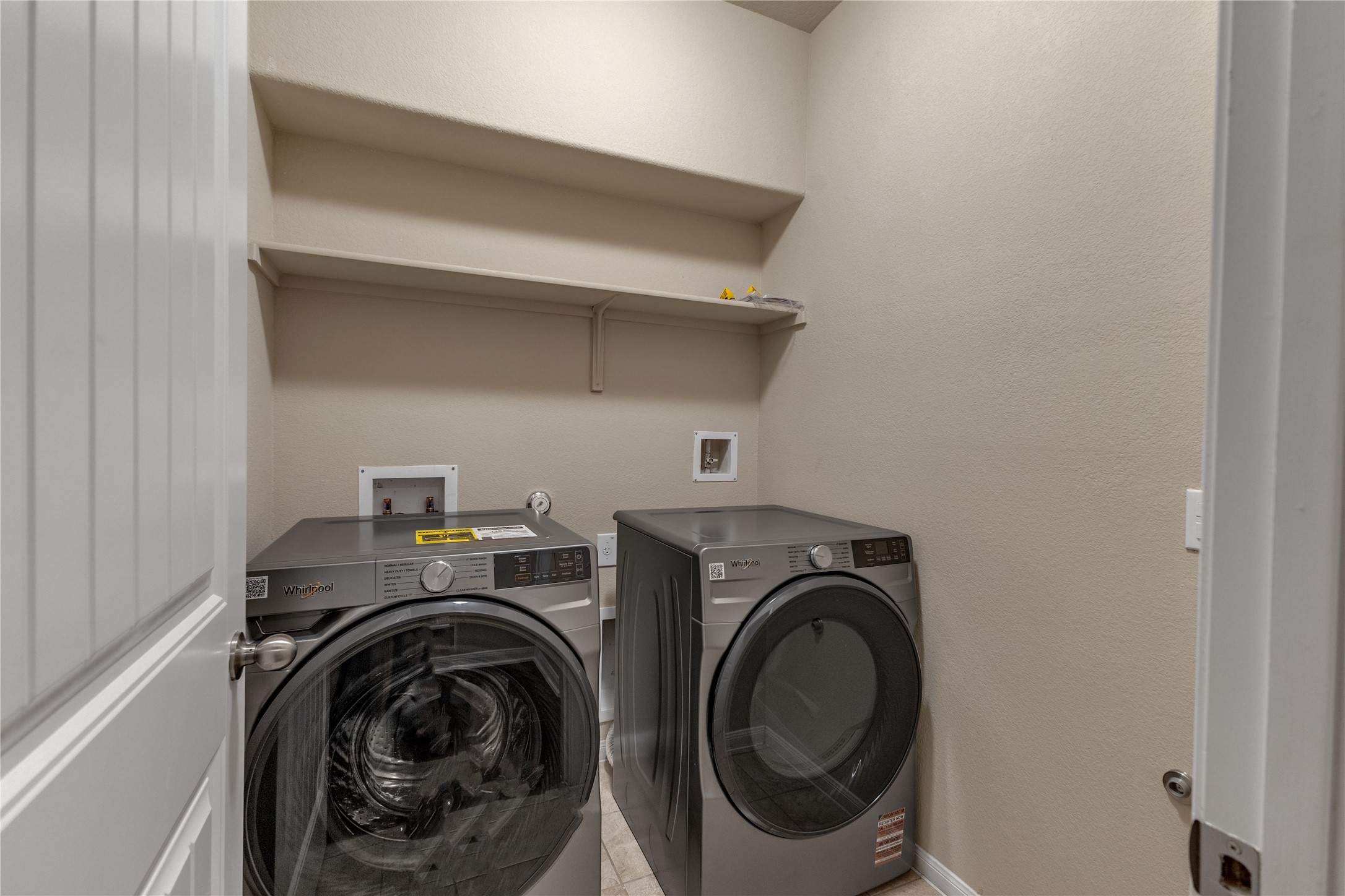 2880 Donnell Drive, Unit 2003 Round Rock, TX 78664 - Photo 29 of 31 Utility area featuring two built-in shelves and a neutral wall color
