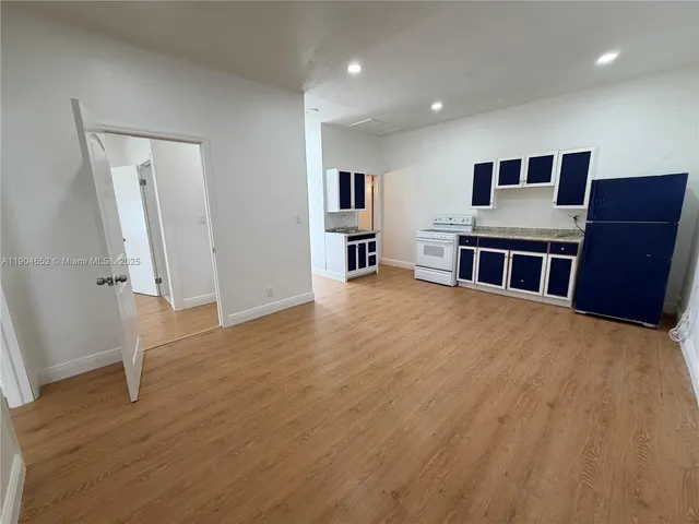 a view of livingroom with hardwood floor and workspace