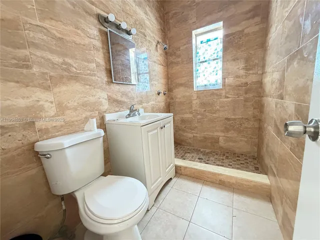 a bathroom with a toilet a sink and shower