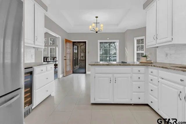 a kitchen with granite countertop white cabinets and white appliances