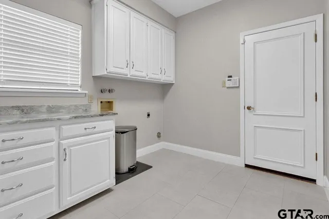 a kitchen with white cabinets and a sink