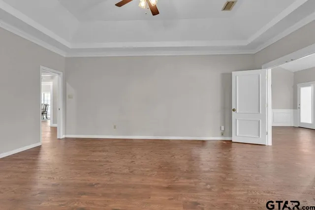 a view of an empty room and wooden floor