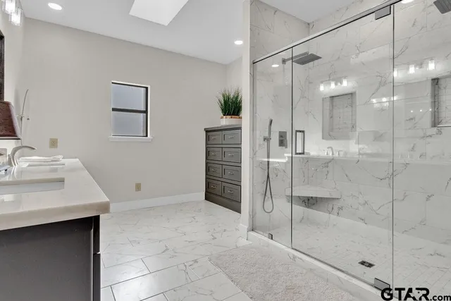 a bathroom with a shower sink and mirror