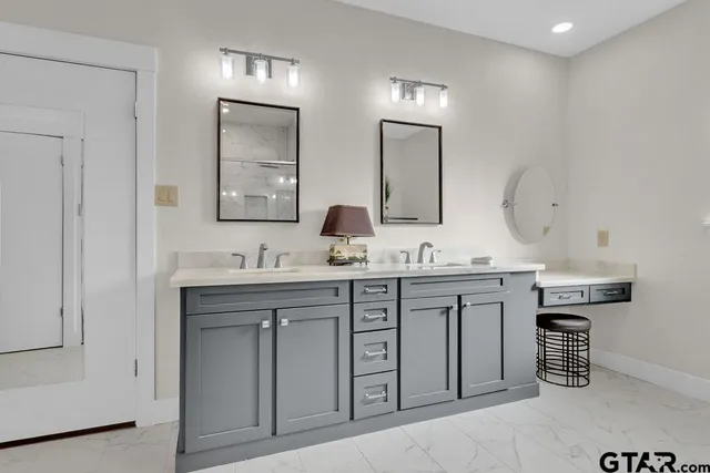 a bathroom with a sink double vanity and a mirror