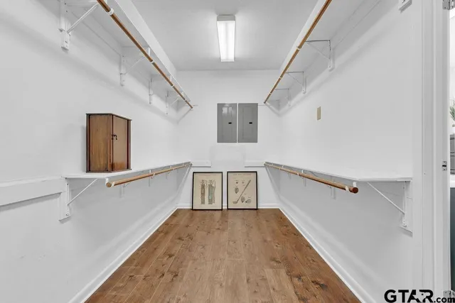 a hallway with furniture and wooden floor