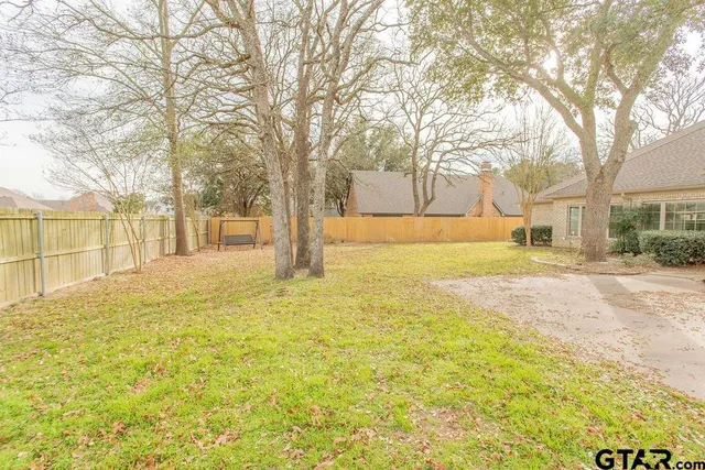 a view of yard with large trees