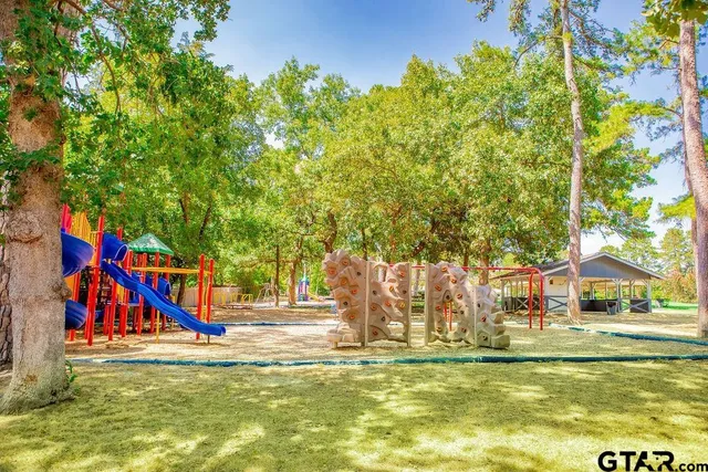 a view of a lake with a yard and mountain view