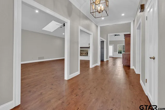 a view of a hallway with wooden floor