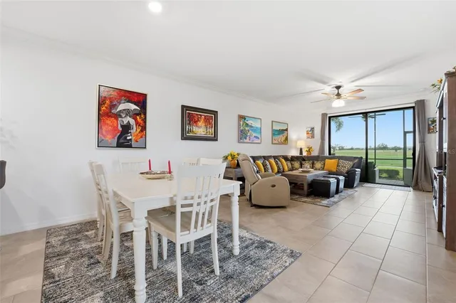 a living room with furniture and a ceiling fan