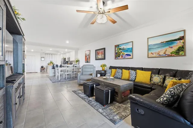 a living room with furniture and a view of kitchen