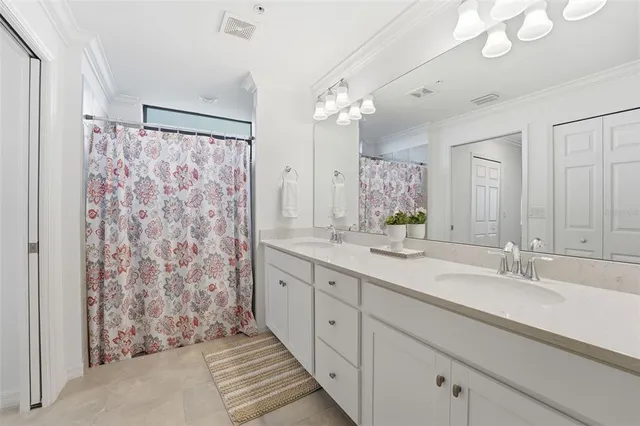 a spacious bathroom with a double vanity sink mirror and shower