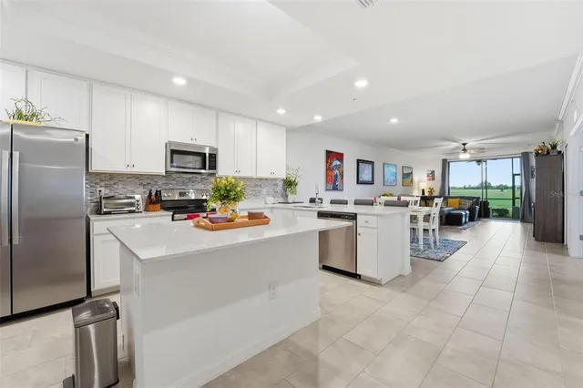 a kitchen with refrigerator and cabinets