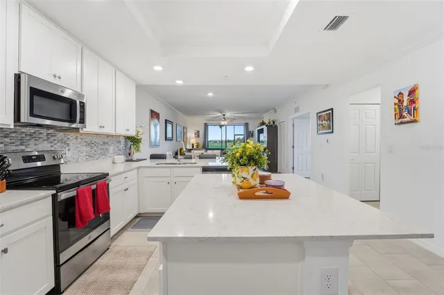 a kitchen with sink cabinets and appliances