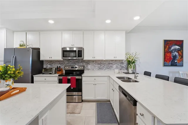 a kitchen with a sink a stove and cabinets