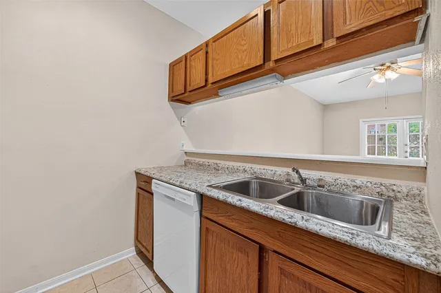 a kitchen with granite countertop a sink and cabinets