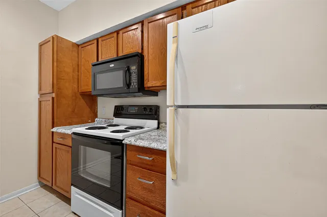 a kitchen with stainless steel appliances granite countertop a stove and a microwave