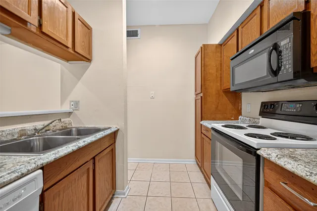 a kitchen that has a sink and a stove