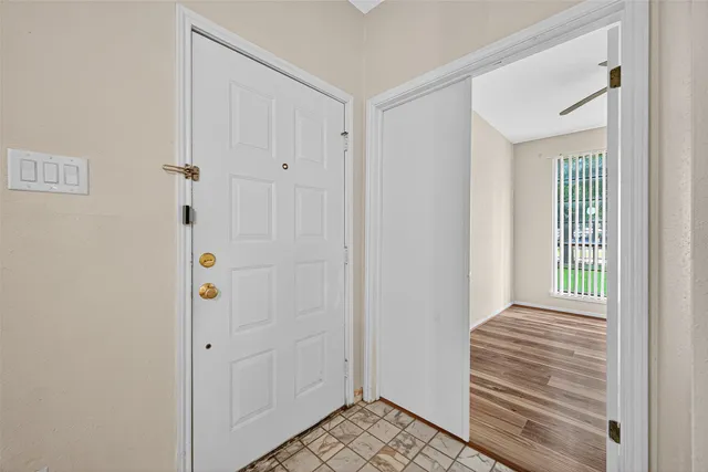 a view of a hallway with wooden floor and closet area